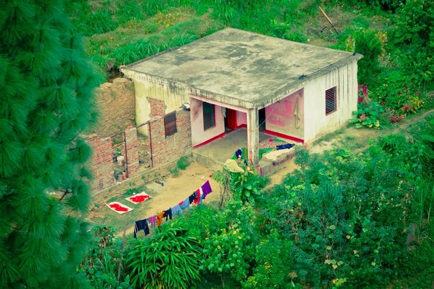 an aerial view of a run down building with clothes hanging out to dry